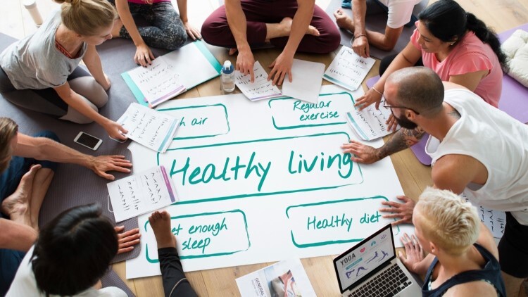 healthy living poster with students surrounding it