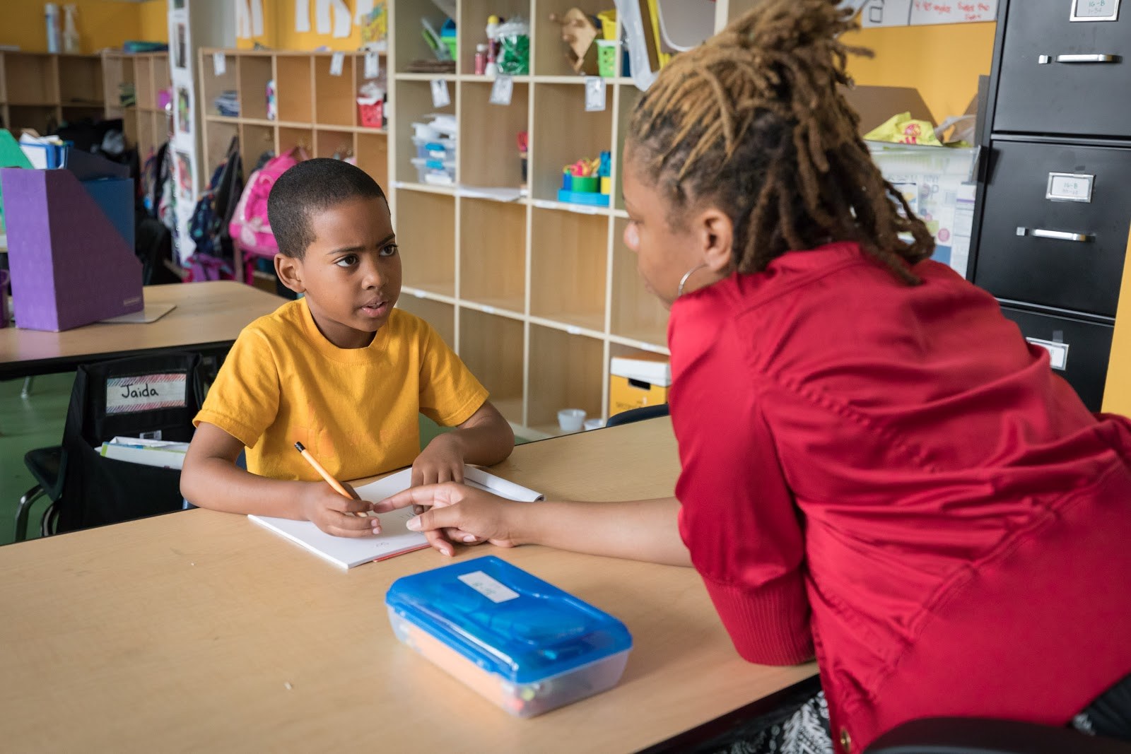 teacher with young student reading