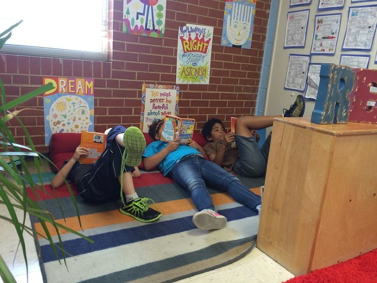 students reading in a comfy corner