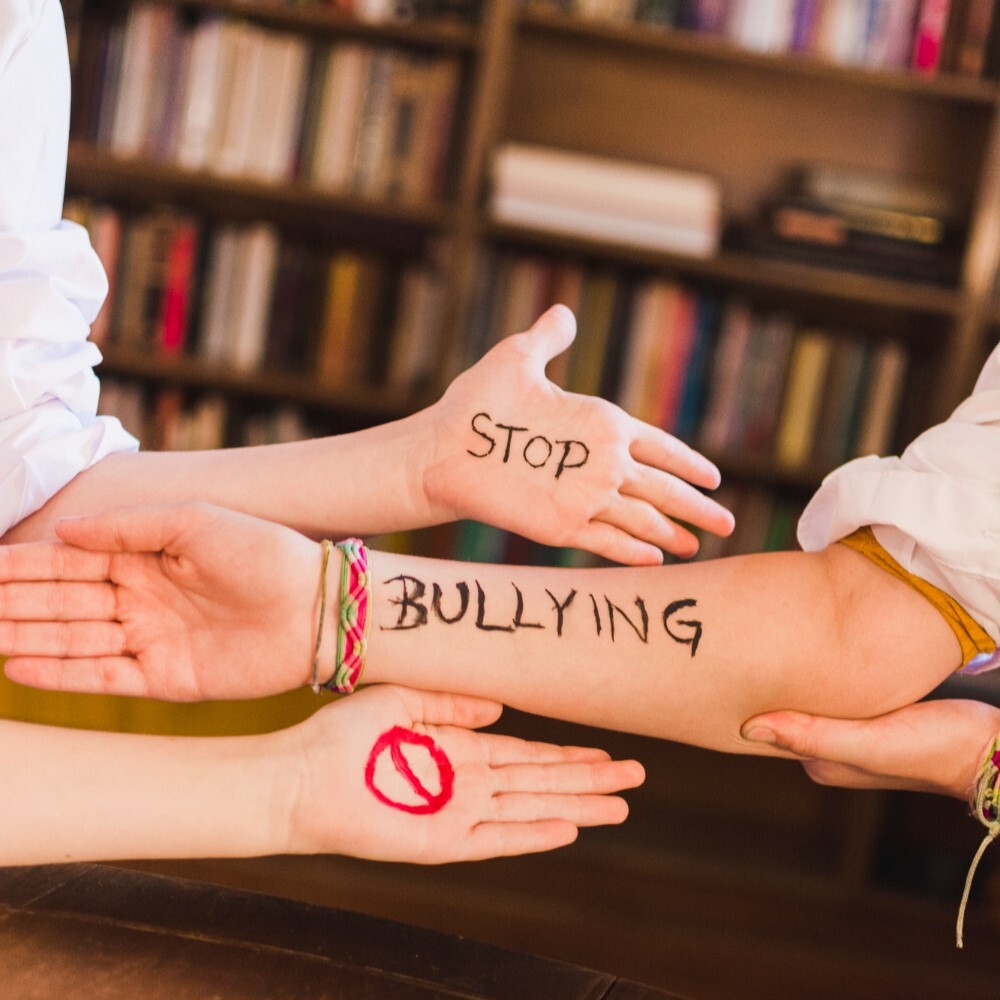 stop bullying slogan on children's arms