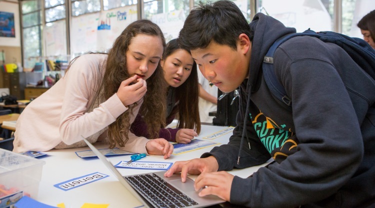 three high school students collaborating