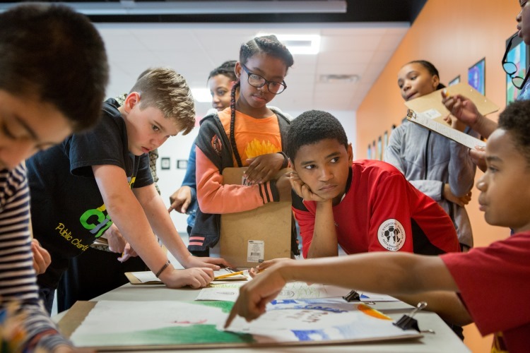 middle school group discuss art project