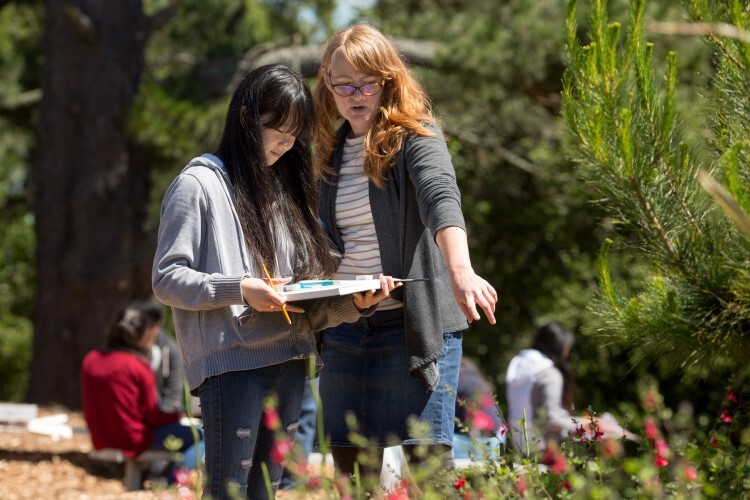 HS girl with teacher outside