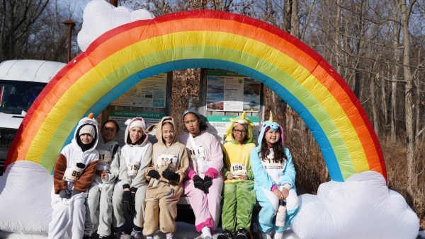 students pose with rainbow