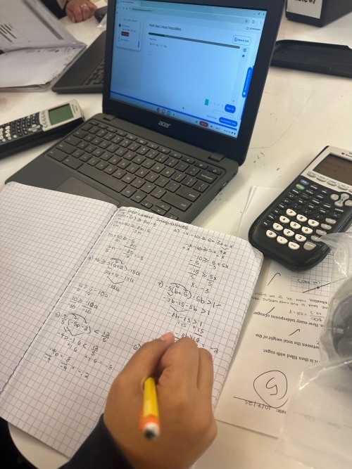 math work with laptop, calculator, and notebook
