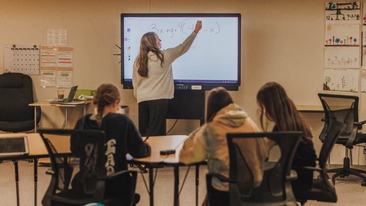 teacher at board in classroom