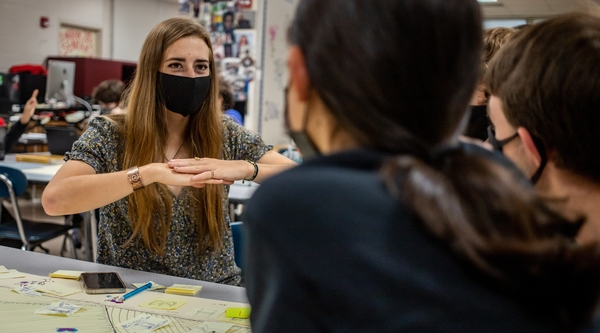 students working with community member