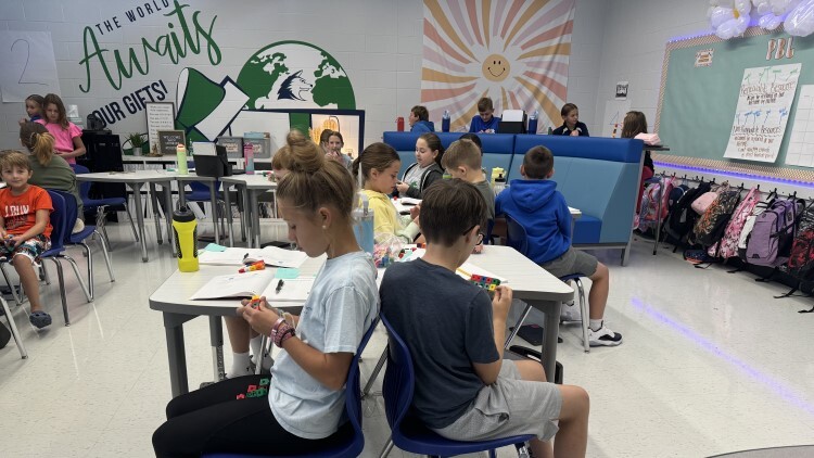 Learners work with hands-on manipulatives