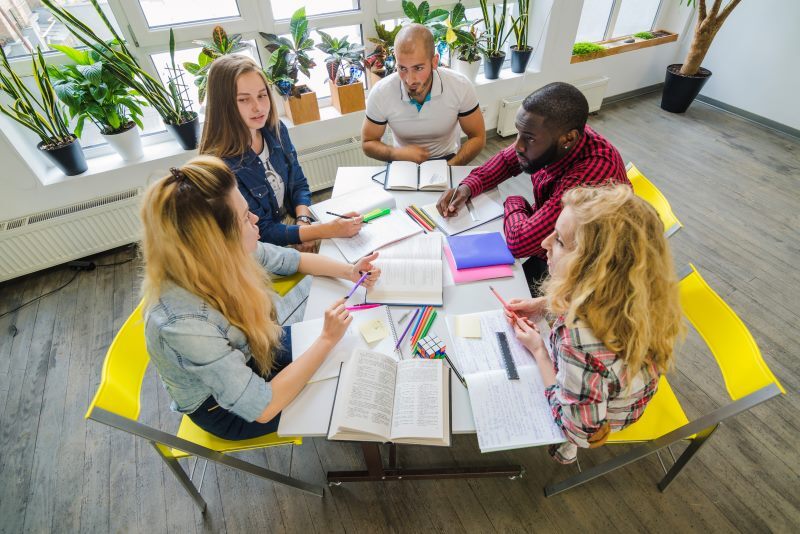 students collaborating at table