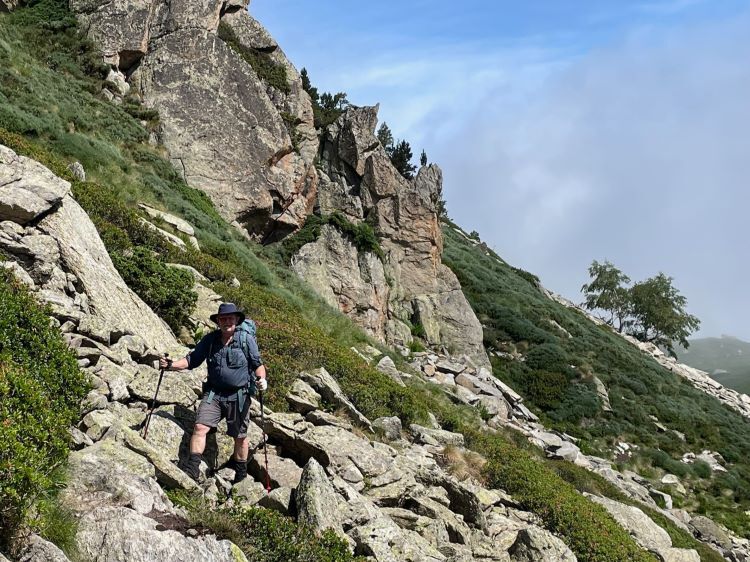 hiker on mountainside trail