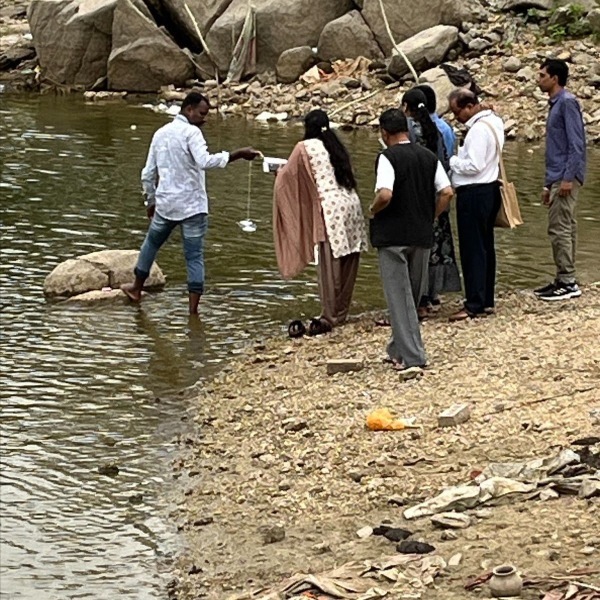 Educators sampling water in ecology field work