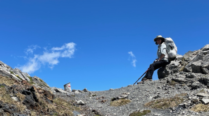 hiker resting at ridge