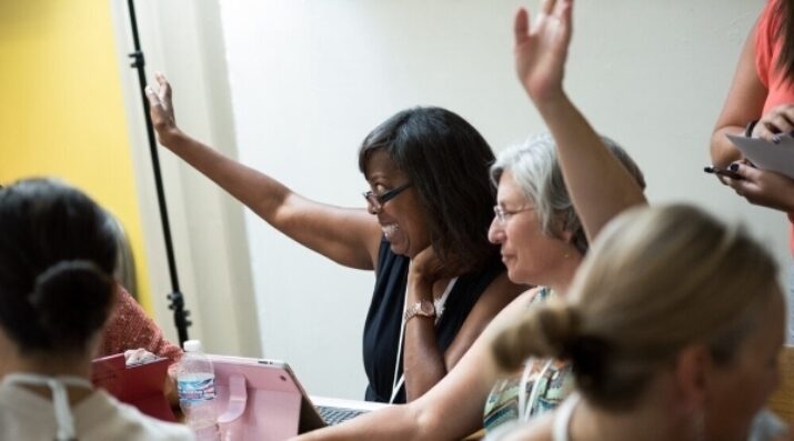 educators raising hands