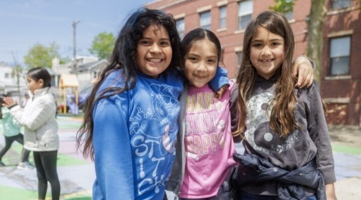 3 elementary students outside at recess