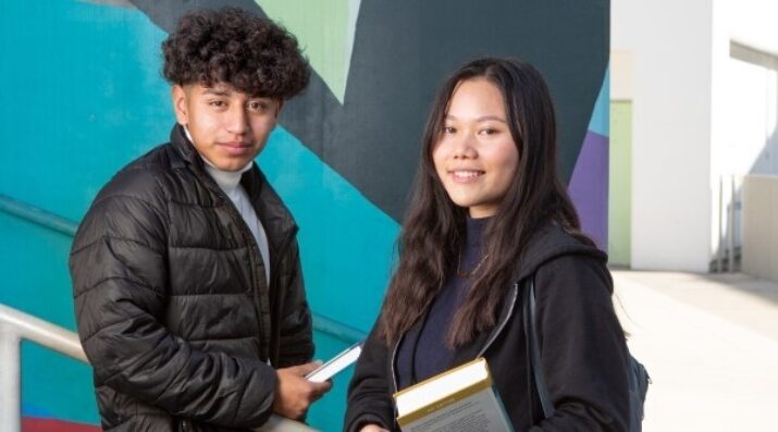 high school students outside holding books