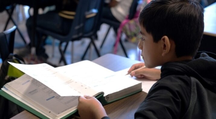middle school boy with textbook