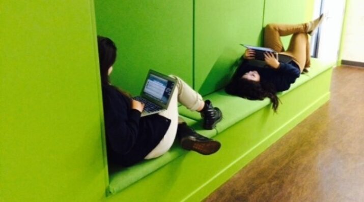 two students share a small nook for individual work
