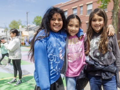 3 elementary students outside at recess