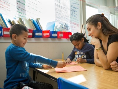 Teacher working with students on their learner profiles