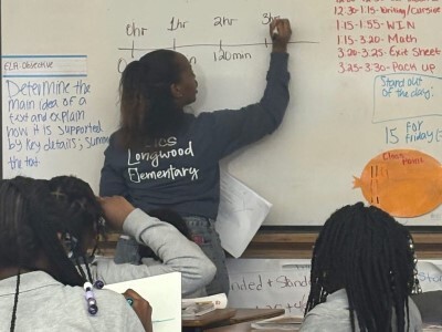 middle school student mathwork at whiteboard