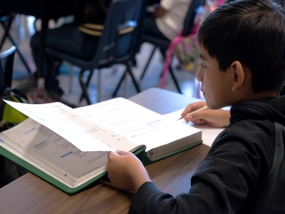 middle school boy with textbook