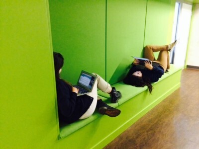 two students share a small nook for individual work